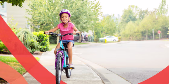 Illustration of a little girl riding bicycle on sidewalk