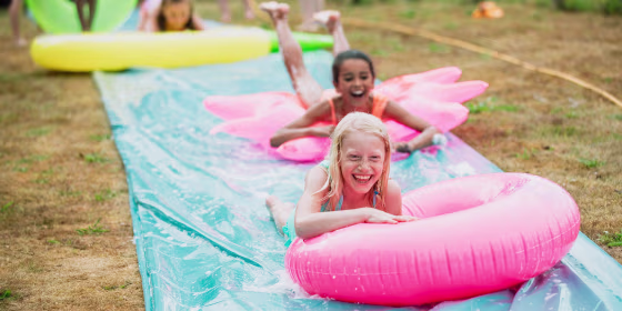 Children Having fun on a Slip 'n' Slide