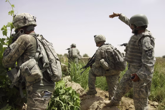 Image: An Afghan interpreter, right, works on a patrol in Afghanistan's Kandahar province on May 8, 2010.