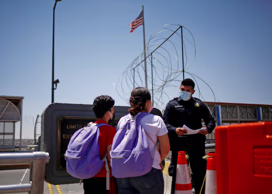 Image: Migrants from Central America walk across the Paso del Norte international border bridge in Ciudad Juarez