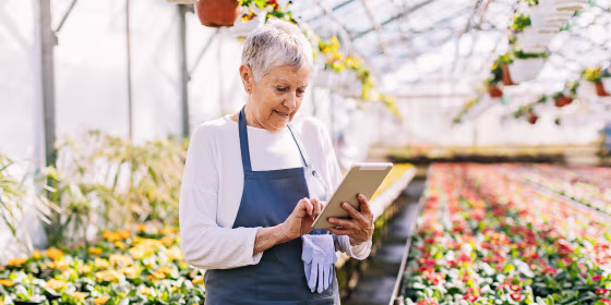 Woman holding a tablet in her garden