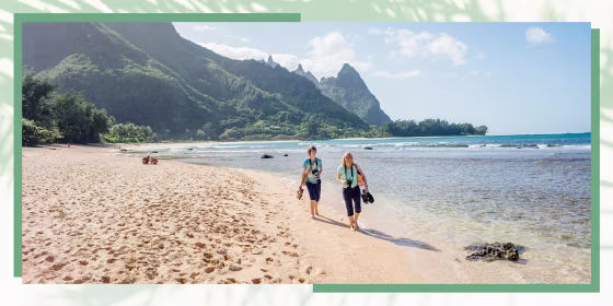 Woman with son walking on beach. Malama Hawaii is a statewide volunteer program that helps travelers experience Hawaii beyond its natural beauty. Malama means to \"give back\" or \"take care.\"