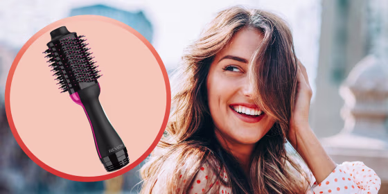 Portrait of a beautiful young woman with pretty hair and a Revlon hot tool. The Revlon One-Step Hair Dryer and Volumizer Brush is trending on TikTok and Amazon. Learn how to use the Revlon hair dryer brush and why users like it.