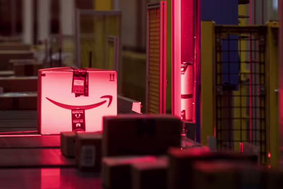 Image: Packages are scanned while moving along a conveyor belt at the Amazon fulfillment center in Robbinsville, N.J.