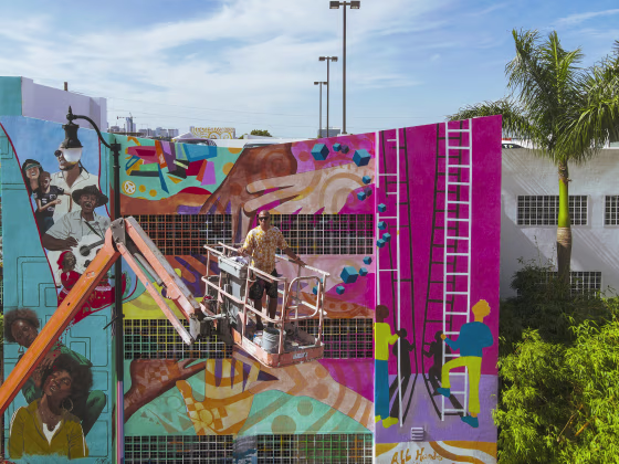 Image: Muralist Kyle Holbrook paints a mural in honor of the victims of the Champlain Tower building collapse on July 14, 2021 in Miami.