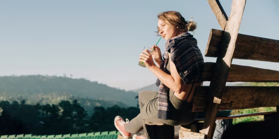 Woman drinking iced tea on the bench