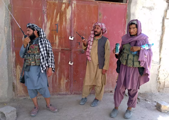 Image: Taliban fighters stand guard at a checkpoint in Farah, southwest Afghanistan, on Aug. 11, 2021.