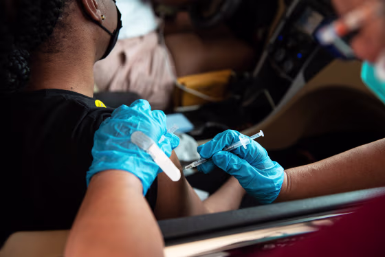 A health care worker administers a dose of the Pfizer Covid-19 vaccination in Birmingham, Ala., on Aug. 28, 2021.
