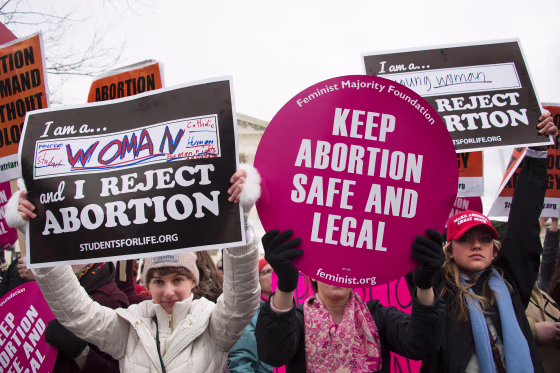 An abortion rights activist demonstrates in the middle of anti-abortion activists in front of the Supreme Court during the March For Life in Washington on Jan. 27, 2017.