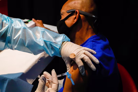 Image: A healthcare worker administers a dose of a Covid-19 vaccine in Miami on Aug. 5, 2021.