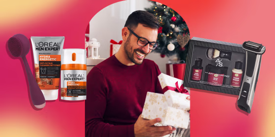 Smiling young man opening Christmas gift at home and some grooming products to buy from Amazon this holiday