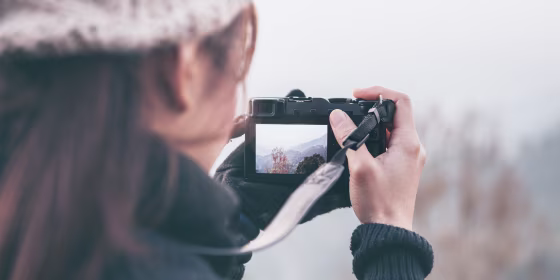 Photographer takes a photo landscape nature with digital mirrorless camera.