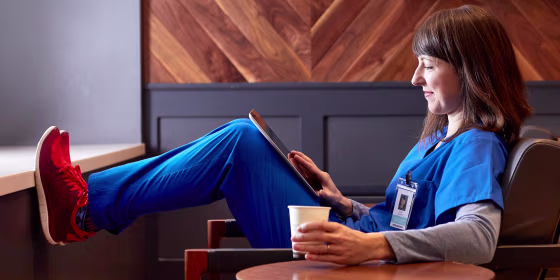 Nurse relaxing in a chair reading