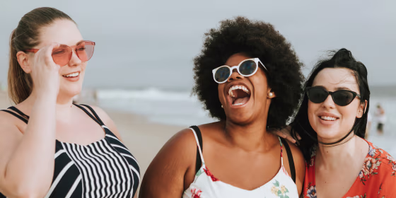 Cheerful diverse plus size women at the beach