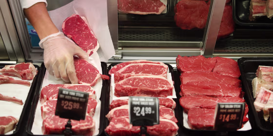 Image: A worker prepares a customer's meat order at a grocery store in Salt Lake City on Oct. 21, 2021.