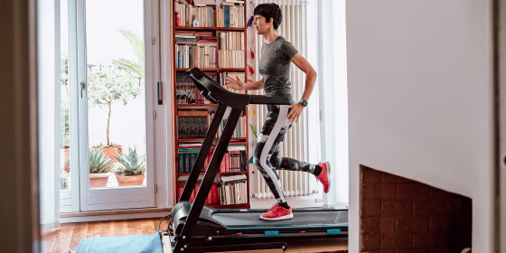 Woman getting fit and doing home training in the living room during lockdown of corona virus crises.