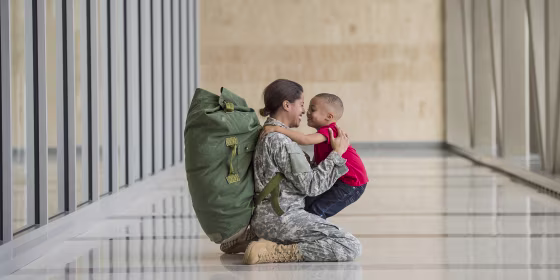 African American soldier hugging son in airport