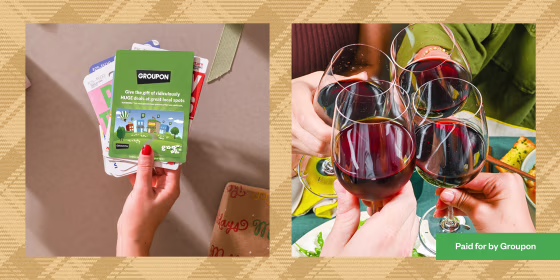 Hand holding a Groupon gift card and friends with wine