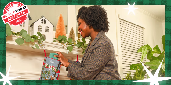 Woman stuffing a stocking on a mantel