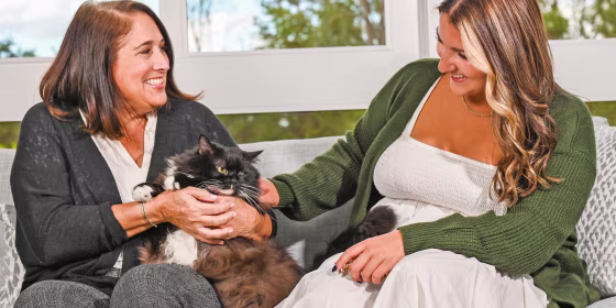 Two woman outside with a cat