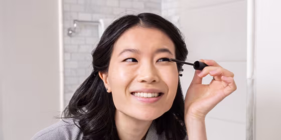 Woman applying mascara