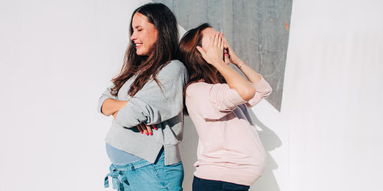 Two pregnant woman outside