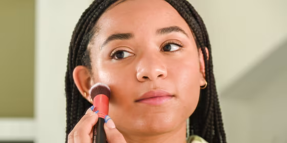 Woman putting on makeup