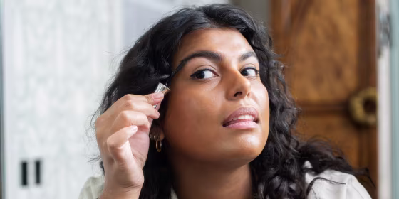 Woman putting something on her brow