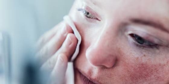 Woman cleaning her face.