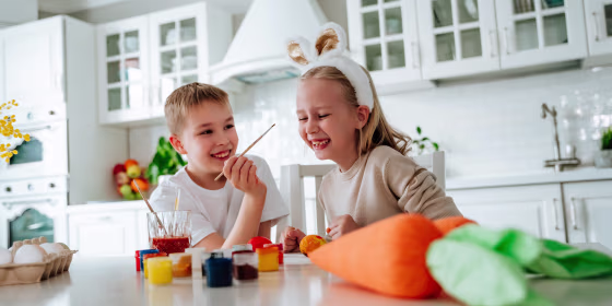 children playing paint themselves with paints