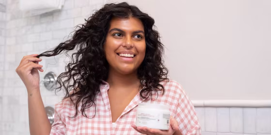 Woman playing with her curly hair