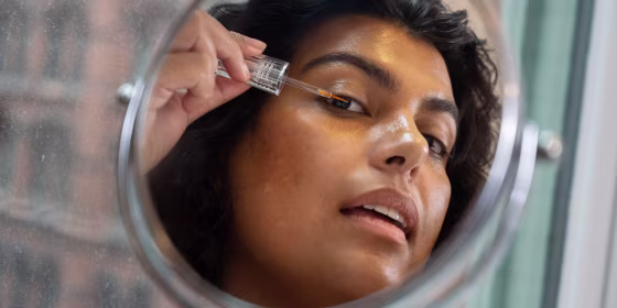Woman putting on Eyelash serum