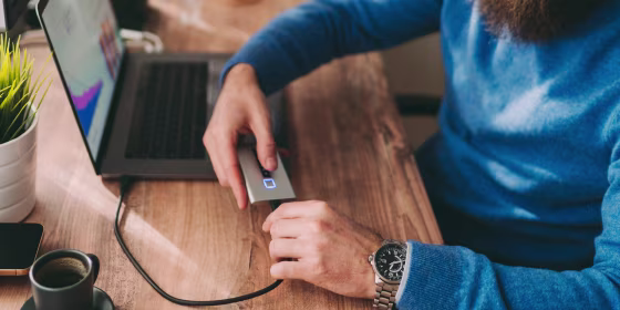 Man plugging in hardrive