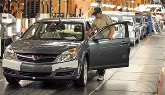 Harrison prepares to drive a Saturn Aura from the assembly line to its final inspection at the General Motors Fairfax Assembly Plant in Kansas City