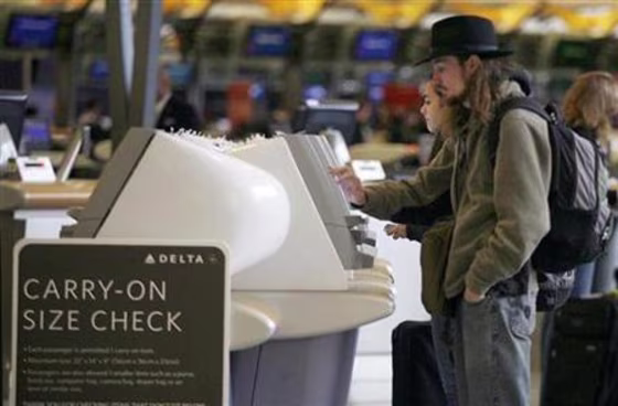Holiday travelers use self check-in kiosks at Hartsfield-Jackson Airport in Atlanta