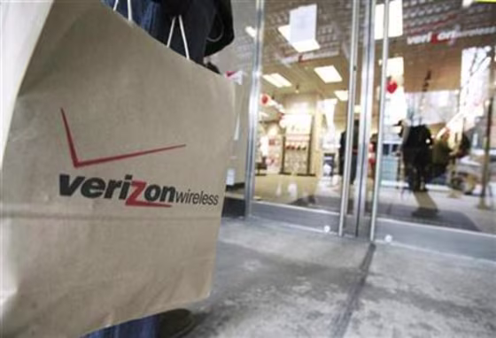 A customer stands outside of a Verizon Wireless store waiting to purchase the new Blackberry Storm phone in New York