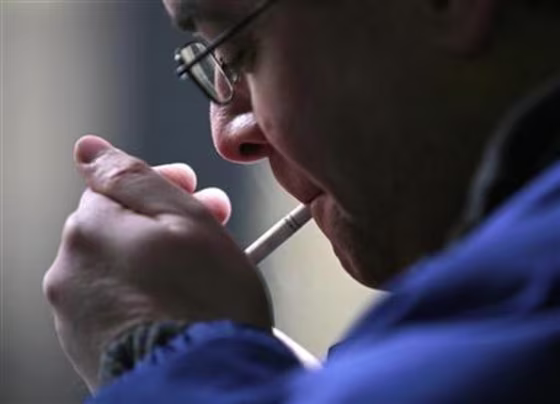 A smoker lights a cigarette