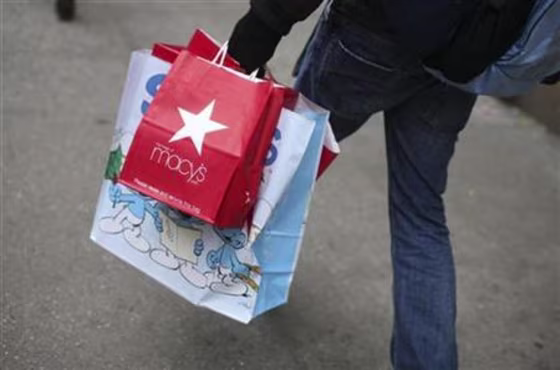 Shopper carries bags along sidewalk in New york
