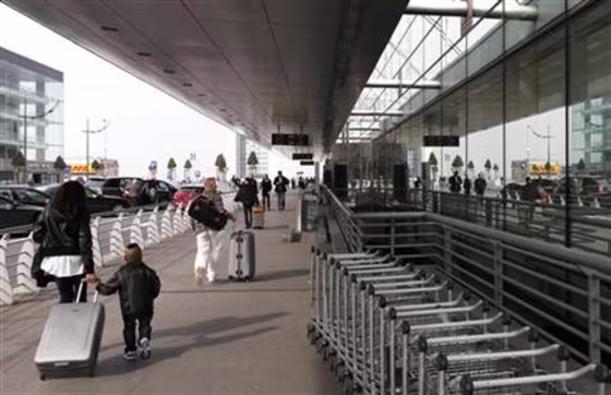 Passengers pull their suitcases outside the main entrance of Zaventem's international airport near Brussels