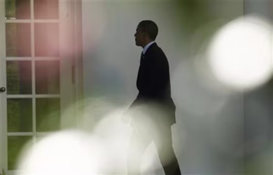 Obama walks to the Oval Office  in Washington
