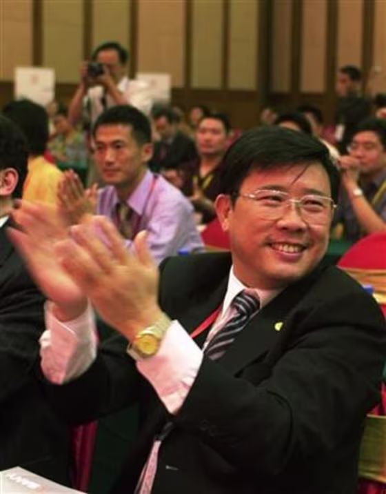 Liang Wengen, chairman and main shareholder of Sany Group, claps during a meeting in Changsha