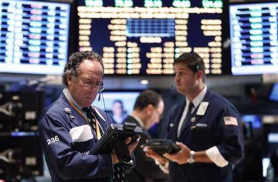 Traders work on the floor of the New York Stock Exchange
