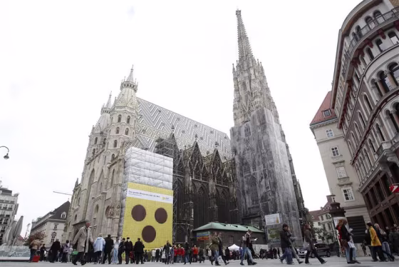 Banner with a symbol of blind people is fixed to St. Stephen's Cathedral in Vienna.