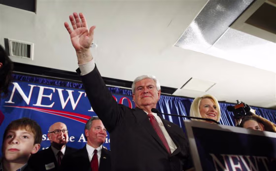 Republican U.S. presidential candidate Gingrich waves to the crowd with his wife Calista at right at his South Carolina primary election night rally in Columbia