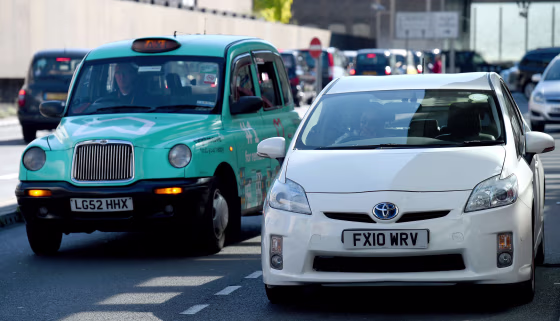 A taxi next to an Uber outside Paddington Station in London on Sept. 22, 2017.