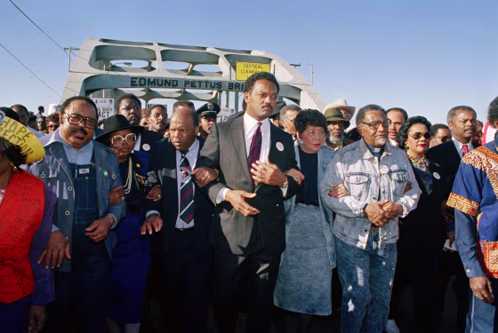 Civil rights figures lead marchers across the Edmund Pettus Bridge during the recreation of the 1965 Selma to Montgomery march in Selma, Ala., March 4, 1990.