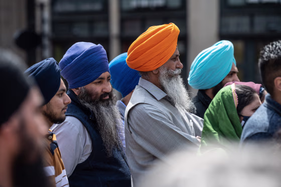 Members of the Sikh community gather and listen during a vigil at Monument Circle on April 18, 2021, in Indianapolis.