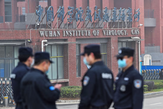 Security personnel stand guard outside the Wuhan Institute of Virology on Feb. 3, 2021.