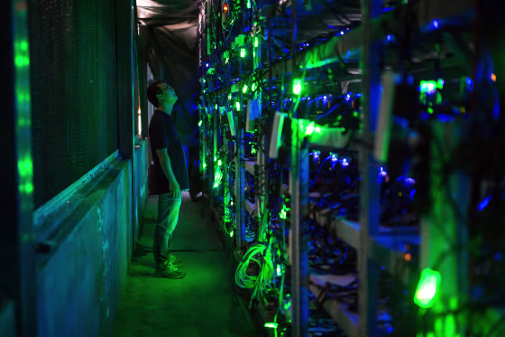 Haobtc's bitcoin mine site manager, Guo-hua, checks mining equipment inside their bitcoin mine near Kongyuxiang, Sichuan, China, on Aug. 12, 2016.