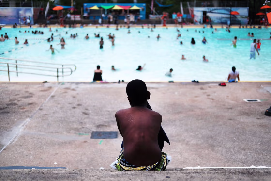 Image: A child takes a break from swimming at the Astoria Pool in Queens, N.Y., on June 29, 2016.